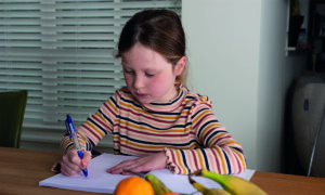 meisje maakt oefenopdrachten in boek