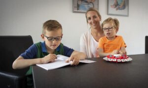 moeder met zoontjes aan tafel