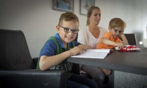 Moeder met twee boertjes aan tafel